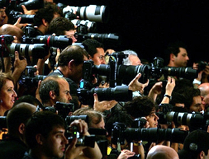 Photographers jostle for the best view at the base of the catwalk