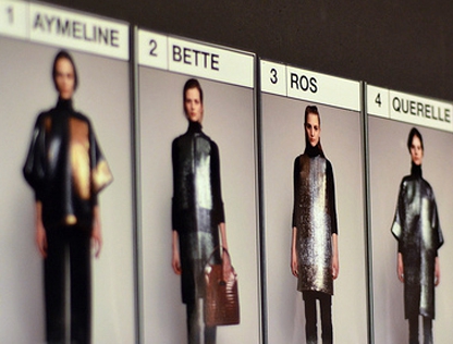 Models' outfits are organized backstage to allow for quick changes